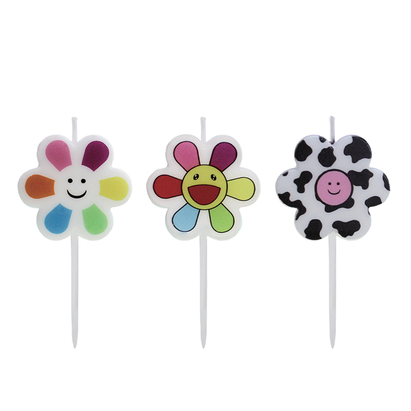 Vela impresa en color con carita sonriente y flores